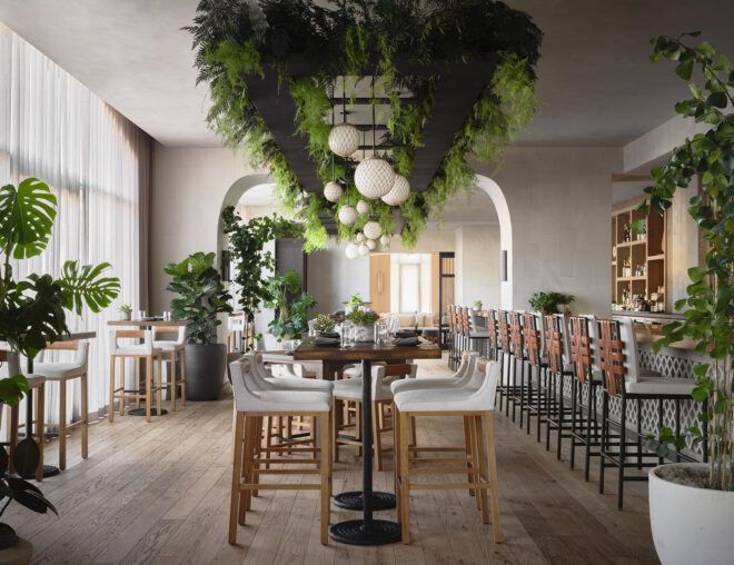 A dining space with plants hanging from the lighting and throughout