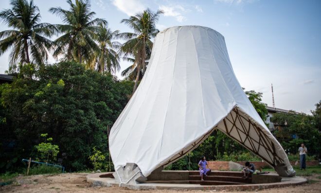 A conical shaped structure draped in a white cloth
