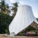 A conical shaped structure draped in a white cloth