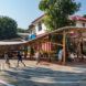 A shaded structure with people playing and standing underneath it