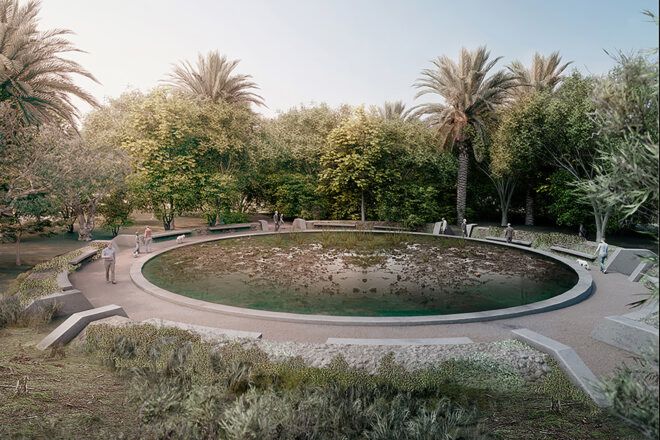 A circular pond surrounded by a walkway, trees and bushes