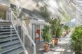 A lower floor with planters in front of a building