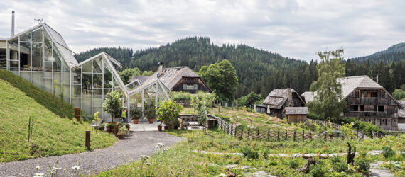 An overview of a greenhouse-like buildings sprawled across a field of grass
