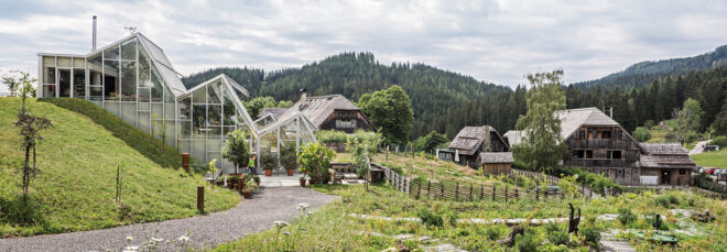 An overview of a greenhouse-like buildings sprawled across a field of grass