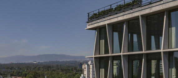 Aerial view of the Castelar 75 facade with Mexico City's skyline and landscape in the background