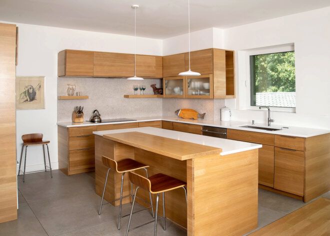 A kitchen with a wooden island and wooden stools