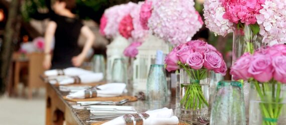 A table with florals and plate settings