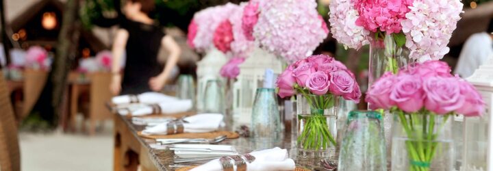 A table with florals and plate settings