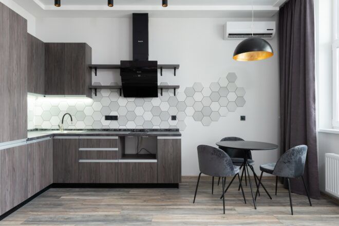 A kitchen and dining room with an air conditioner in the corner