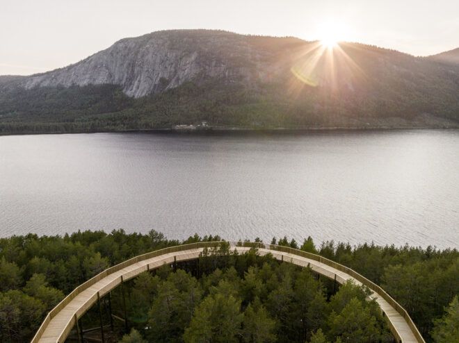 A rounded pathway that overlooks a lake and mountain scenery