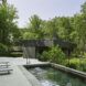 A rectangular pool with seating beside it